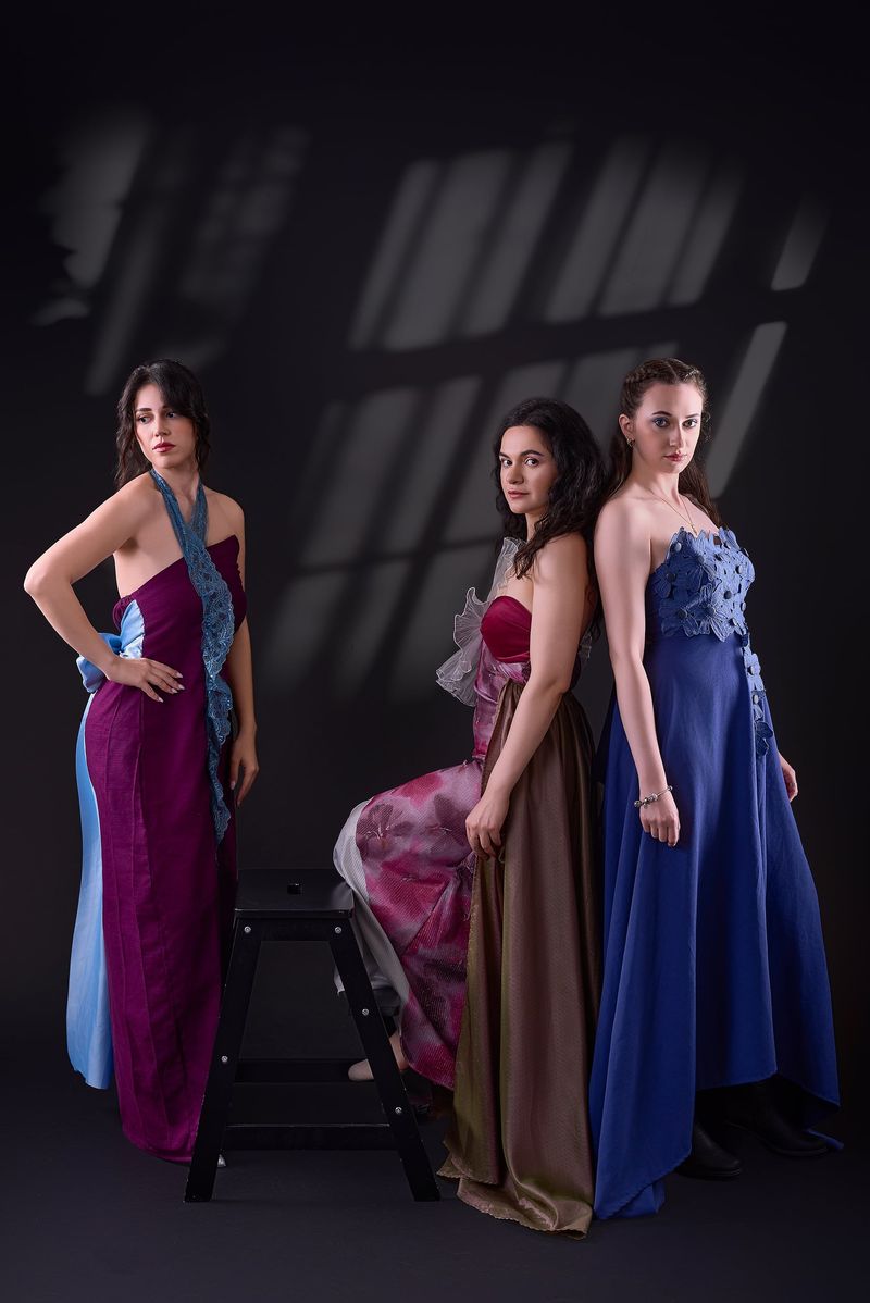 Plum halter gown with blue trim, a pink and bronze gown and a cobalt gown