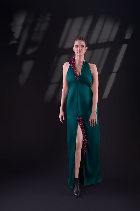 Teal halter-neck evening gown with a front slit and red ruffle trim